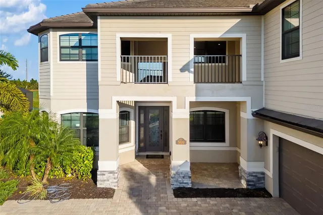 a front view of a house with garden and porch