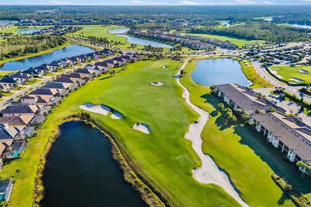 a living room with furniture and floor to ceiling windows