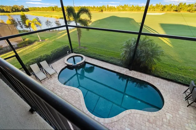 a view of a patio with table and chairs under an umbrella with wooden floor