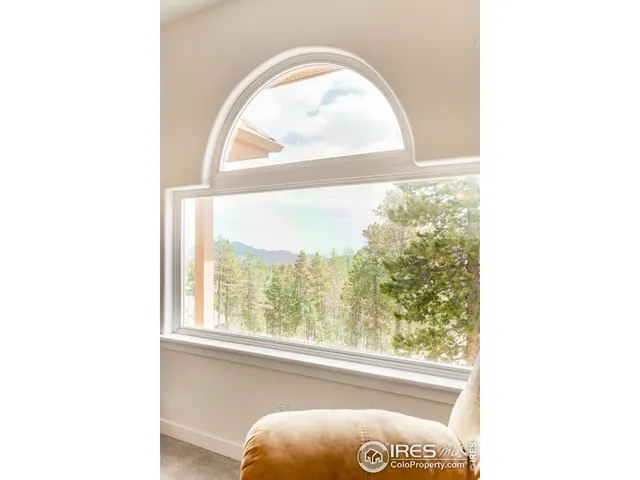 a spacious bedroom with a bed and a large window