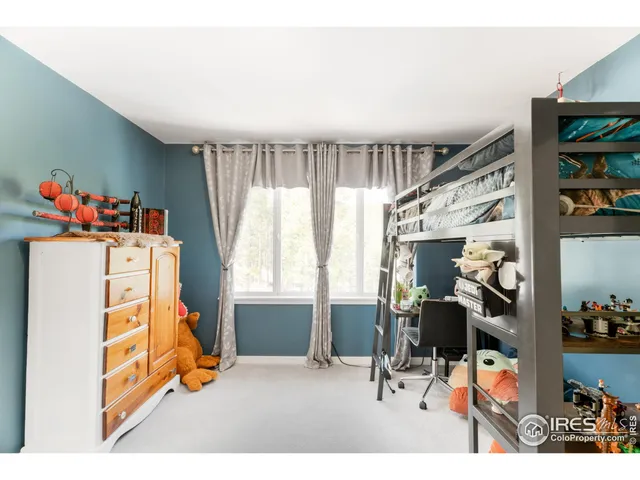 a bedroom with a bed and with furniture