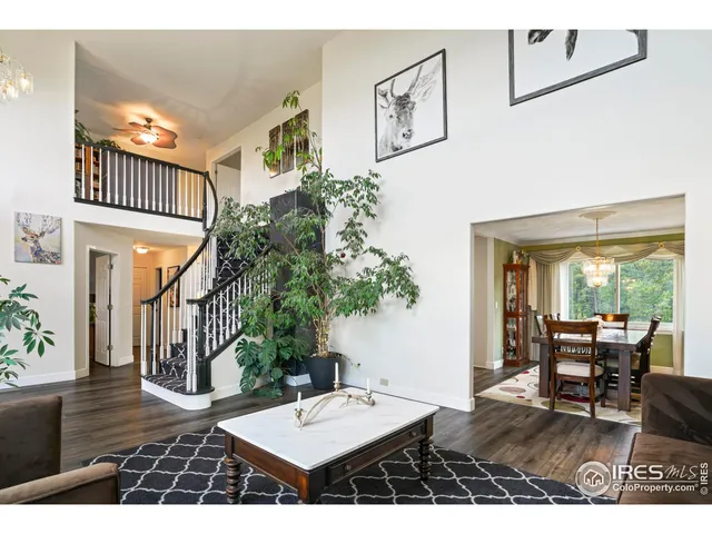 a living room with furniture a rug and a large window