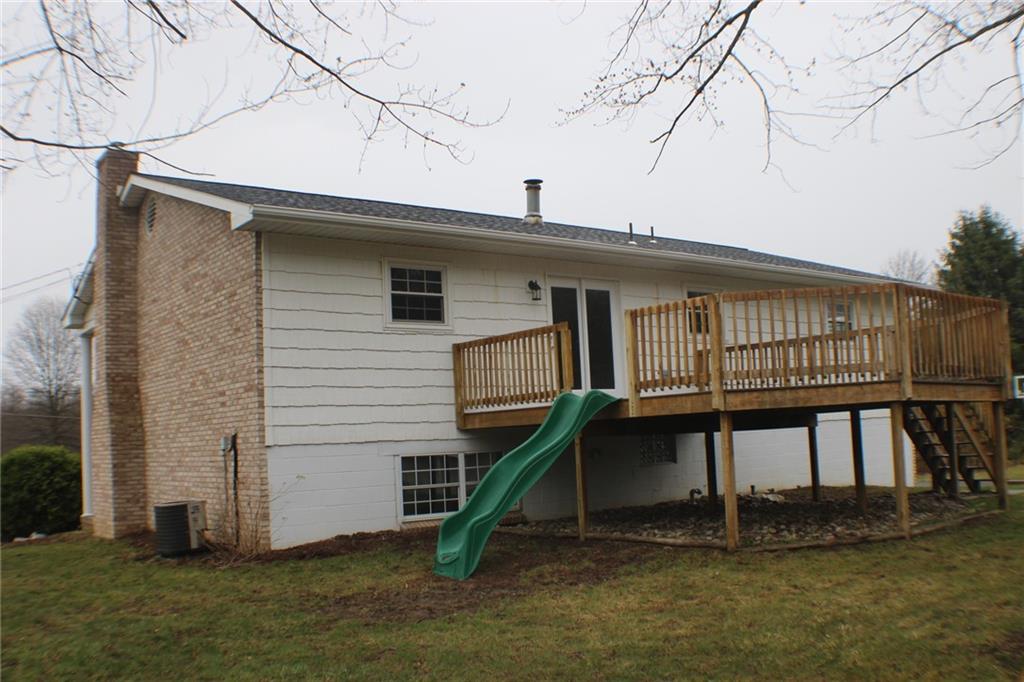 626 Ekastown Road Sarver, PA 16055 - Photo 42 of 50 a small white house with a white roof and table and chairs under an umbrella