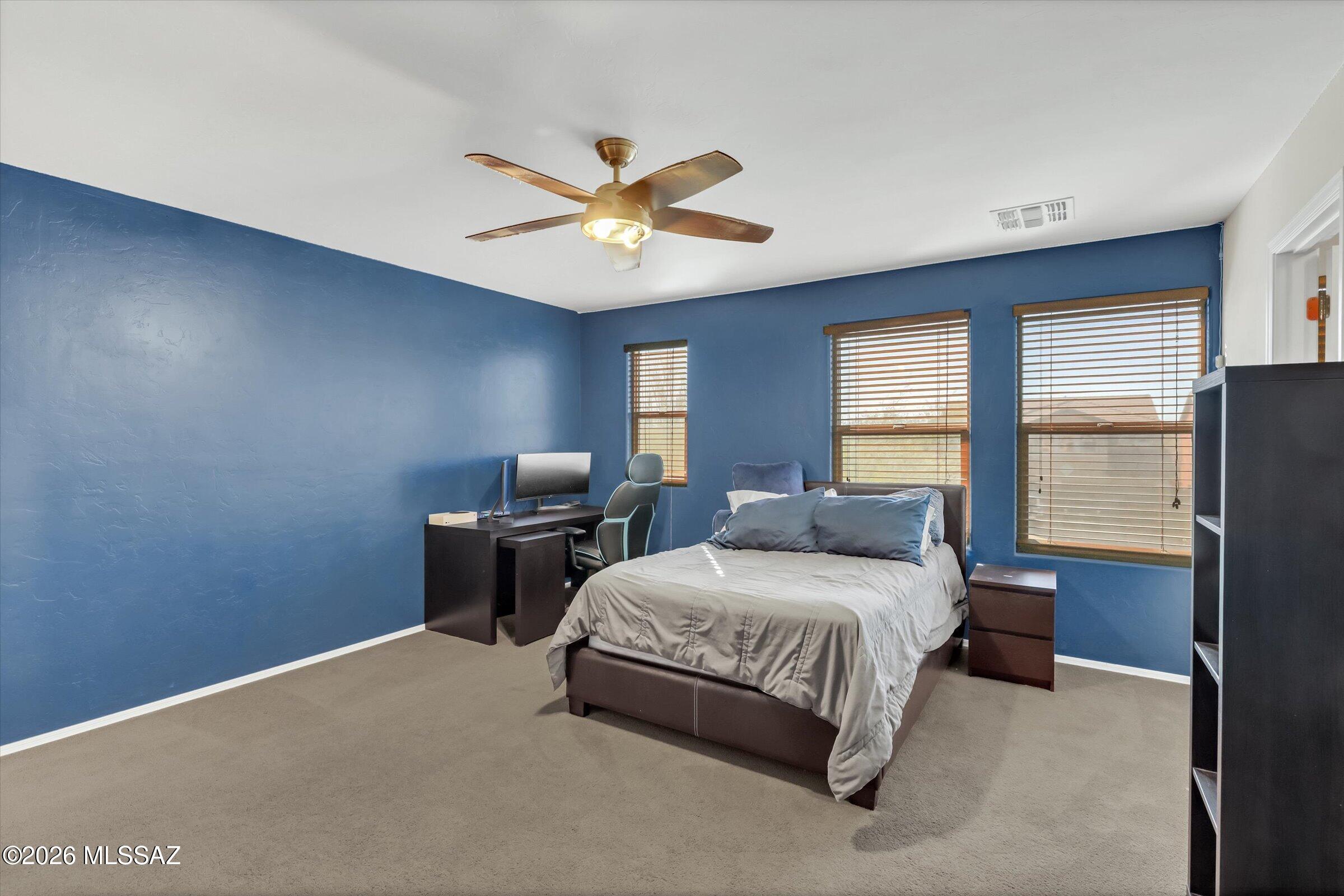 6095 South Jakemp Trail Tucson, AZ 85747 - Photo 41 of 52 a bedroom with a bed and window