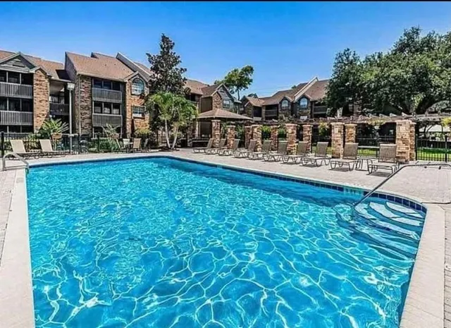 a swimming pool with outdoor seating and yard