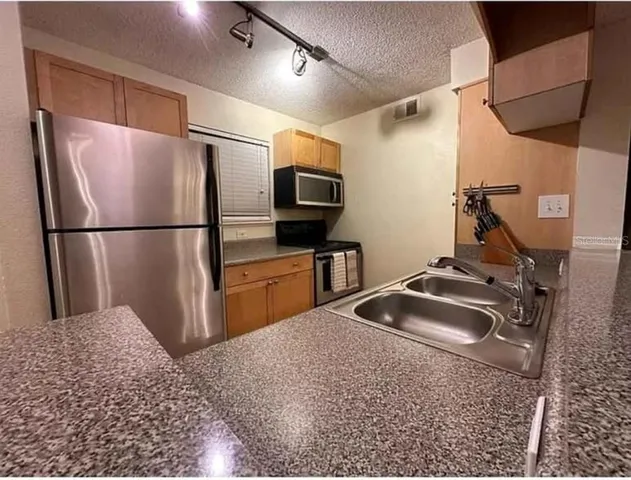 a bathroom with a sink mirror toilet and shower