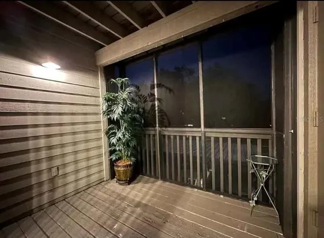 a living room with furniture a clock and a chandelier