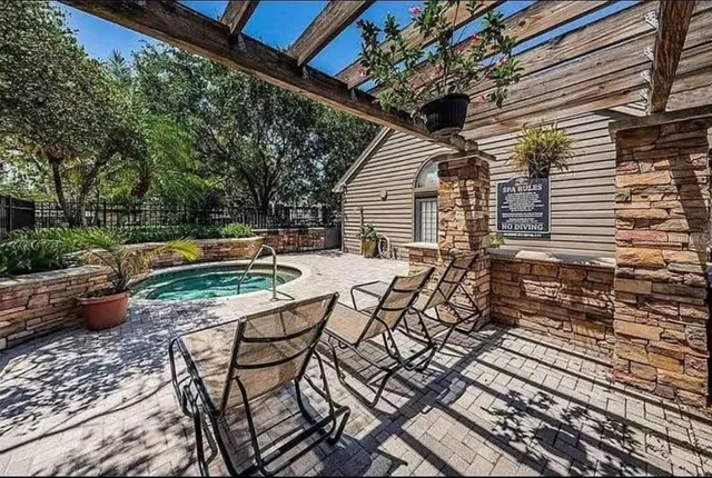 a view of backyard with table and chairs and wooden fence