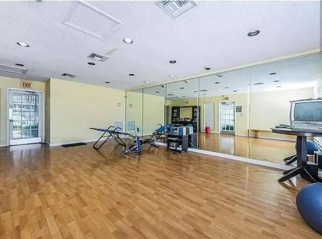 a view of a room with gym equipment and a large window