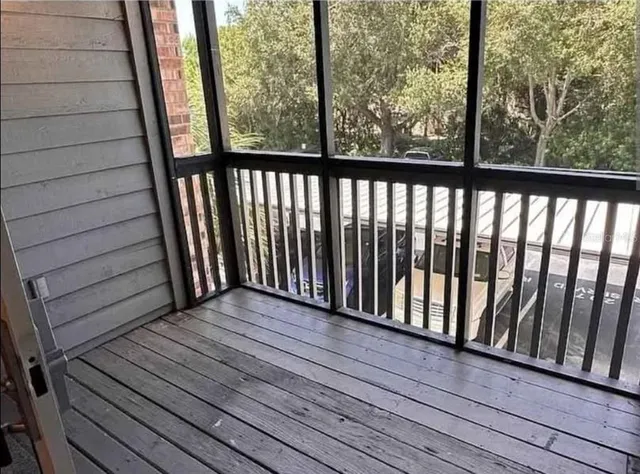 a view of a balcony with wooden floor