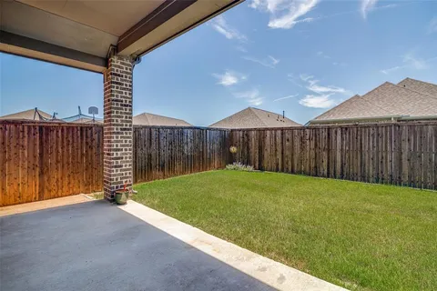 a view of a backyard with wooden fence