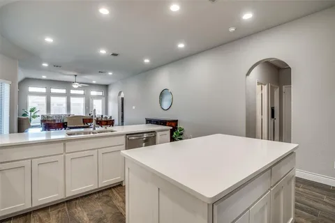 a kitchen with sink and white cabinets