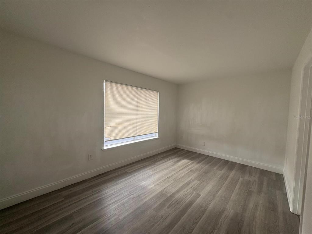 4033 Henley Road, Unit 1707 Orlando, FL 32839 - Photo 50 of 66 an empty room with wooden floor and windows