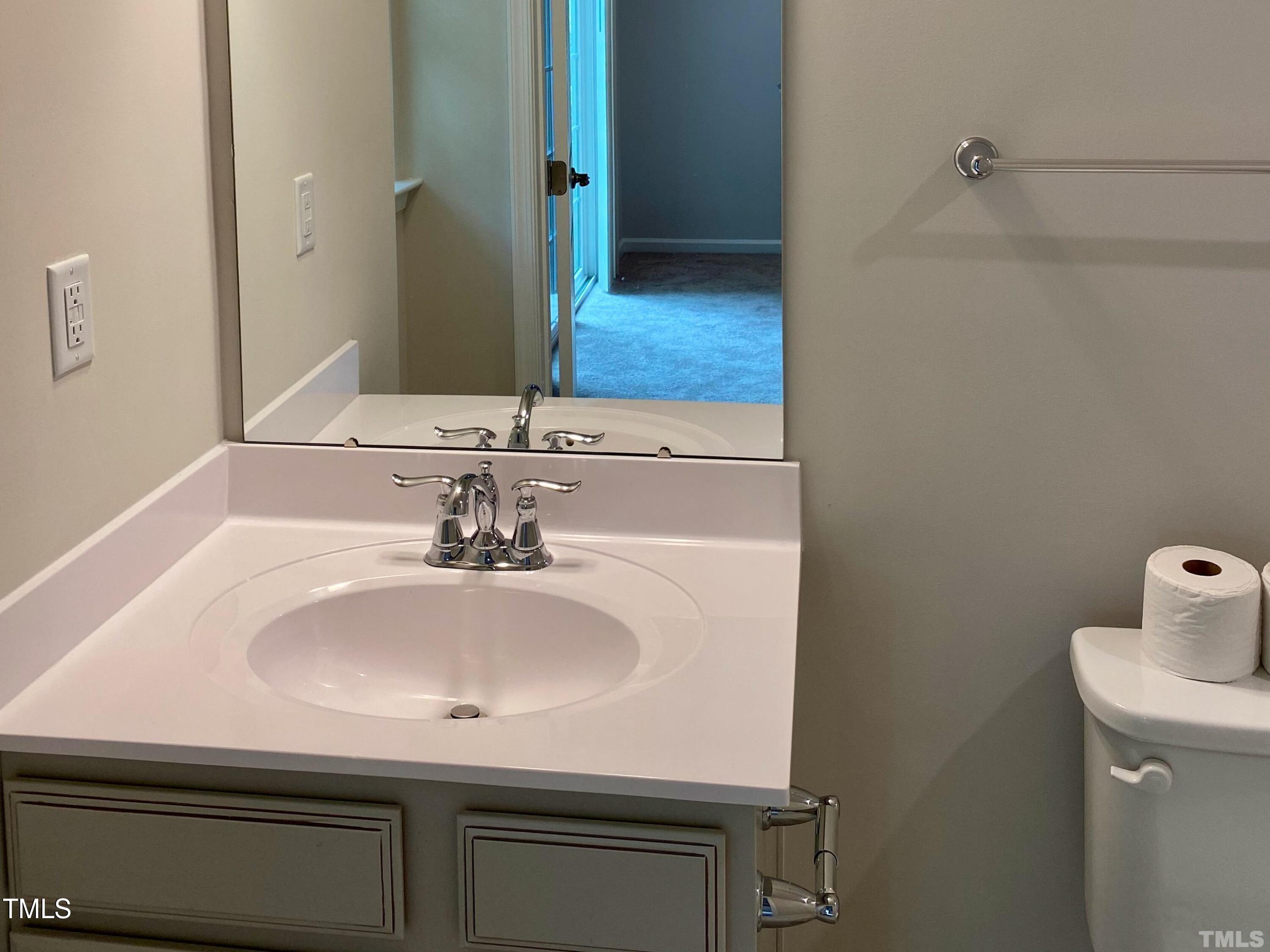 6627 Pathfinder Way Raleigh, NC 27616 - Photo 18 of 35 a bathroom with a sink and a mirror