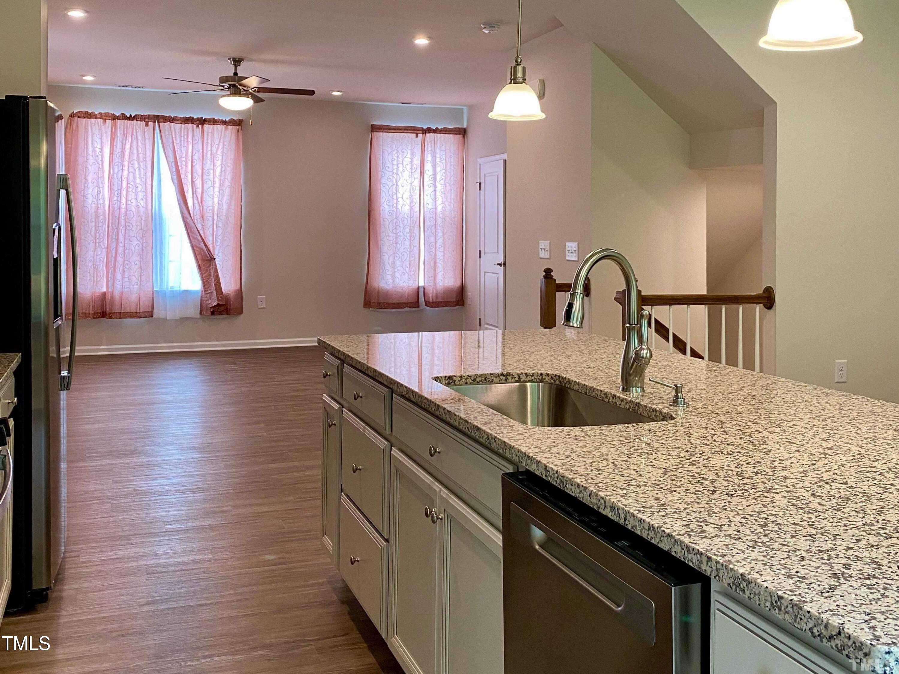6627 Pathfinder Way Raleigh, NC 27616 - Photo 9 of 35 a kitchen with kitchen island granite countertop a sink a counter top space and cabinets