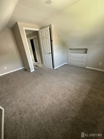 an empty room with stairs and white walls