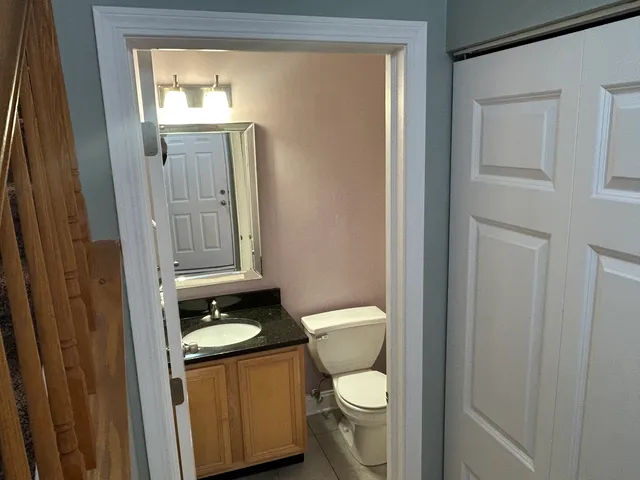 a white toilet sitting next to a bathroom sink