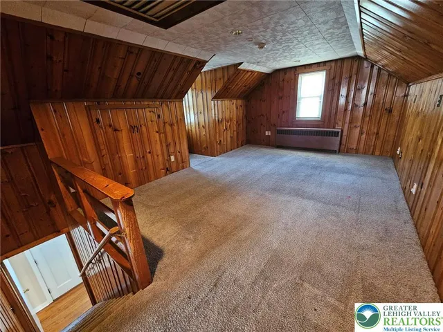 a view of an empty room with a fireplace