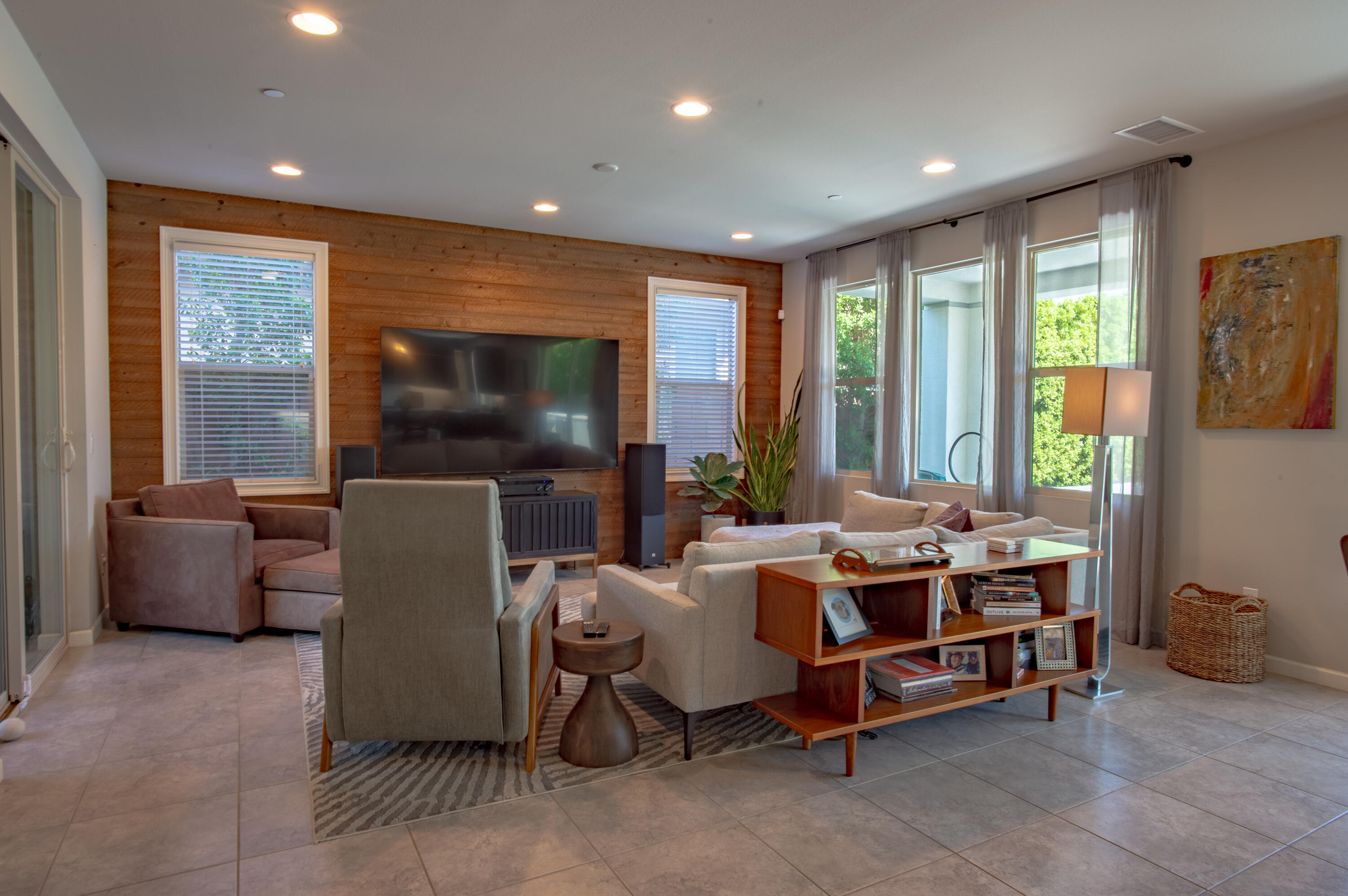 74500 Xander Court Palm Desert, CA 92211 - Photo 12 of 36 a living room with furniture a flat screen tv and a floor to ceiling window