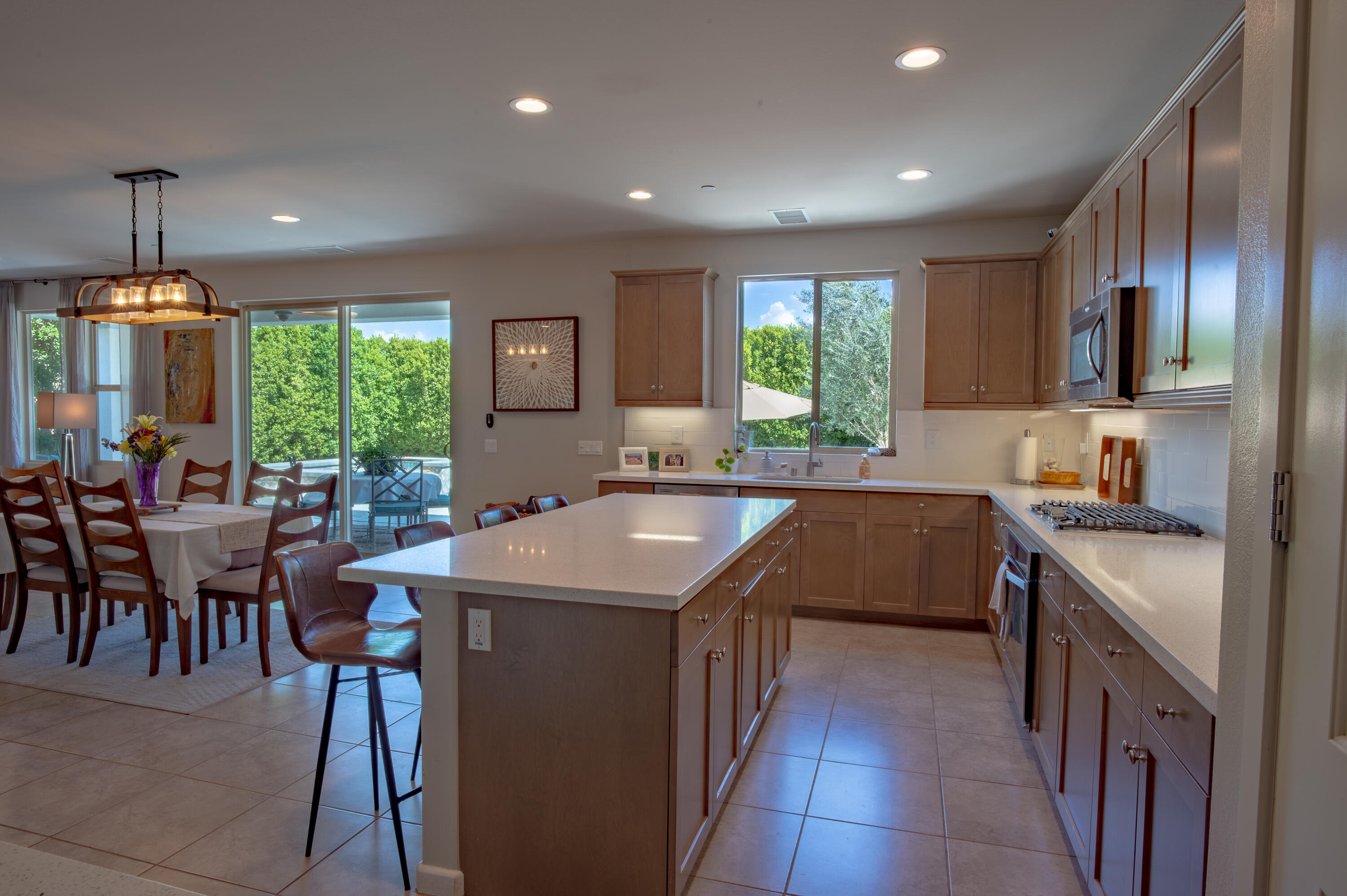 74500 Xander Court Palm Desert, CA 92211 - Photo 17 of 36 a kitchen with kitchen island granite countertop a sink a counter top space appliances and a center island