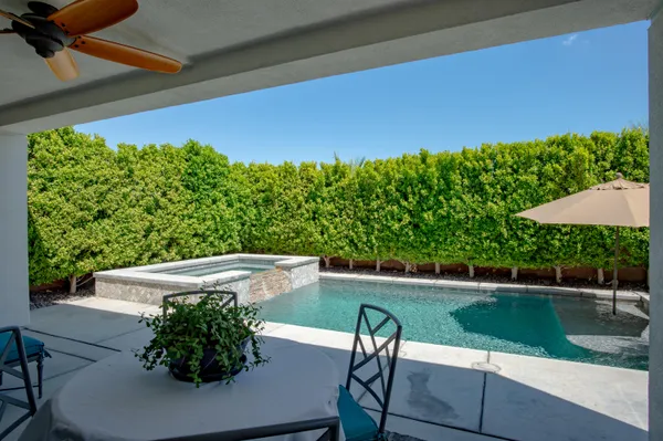 a view of a backyard with sitting area