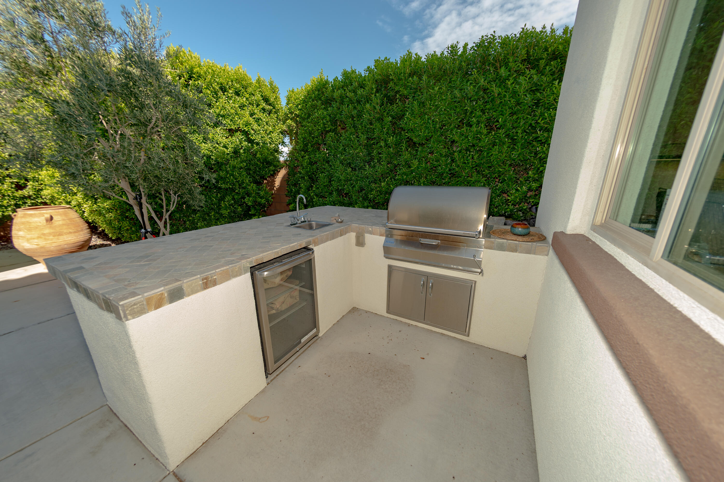 74500 Xander Court Palm Desert, CA 92211 - Photo 22 of 36 a view of a kitchen with a sink and dishwasher
