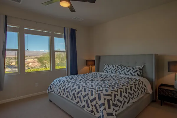 a bedroom with a bed and lamps