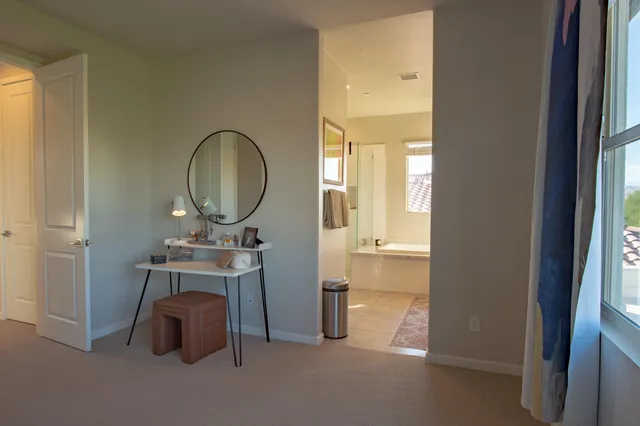 a bathroom with a granite countertop sink mirror and a bathtub