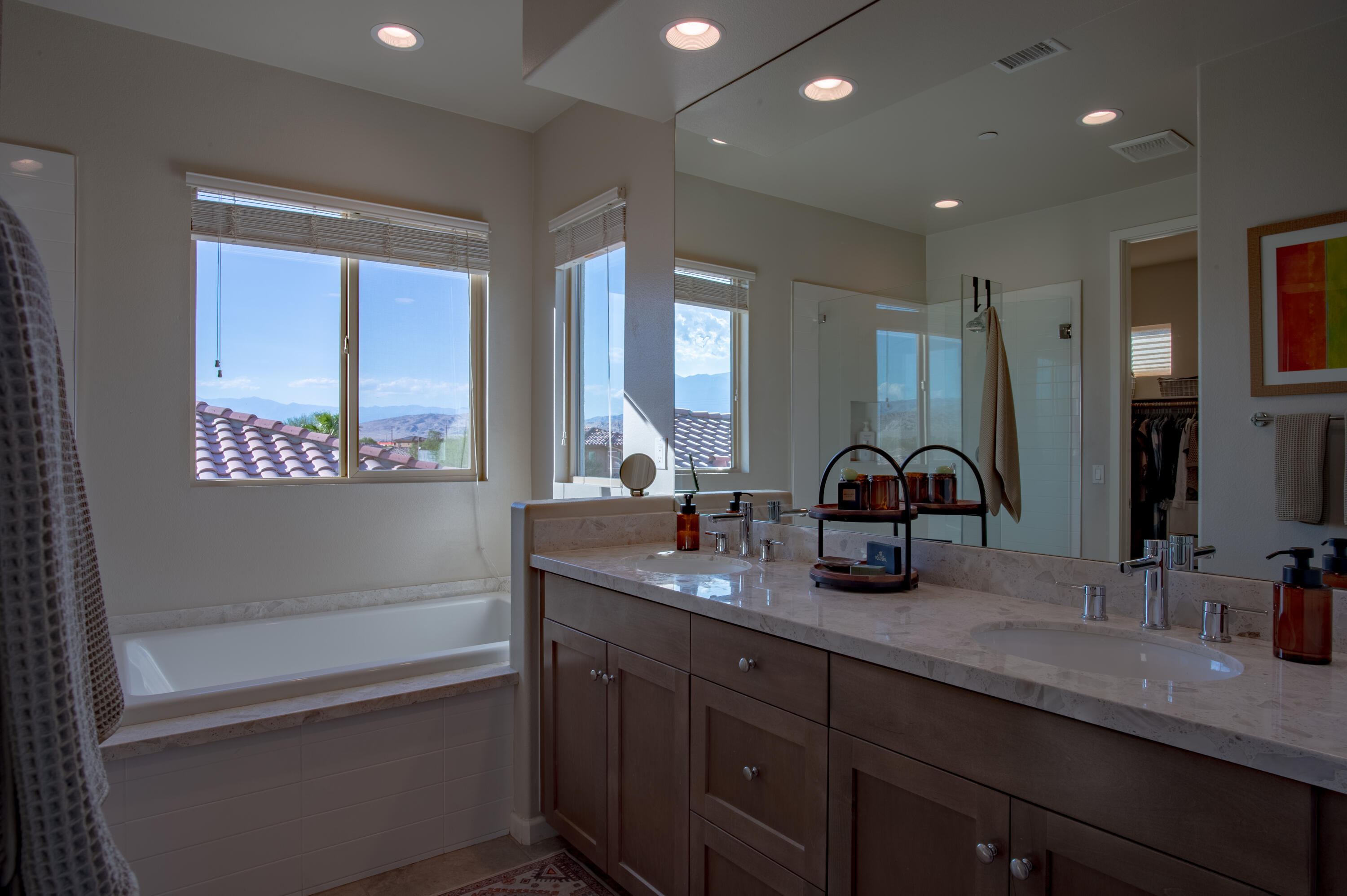 74500 Xander Court Palm Desert, CA 92211 - Photo 27 of 36 a bathroom with a granite countertop sink mirror and a bathtub