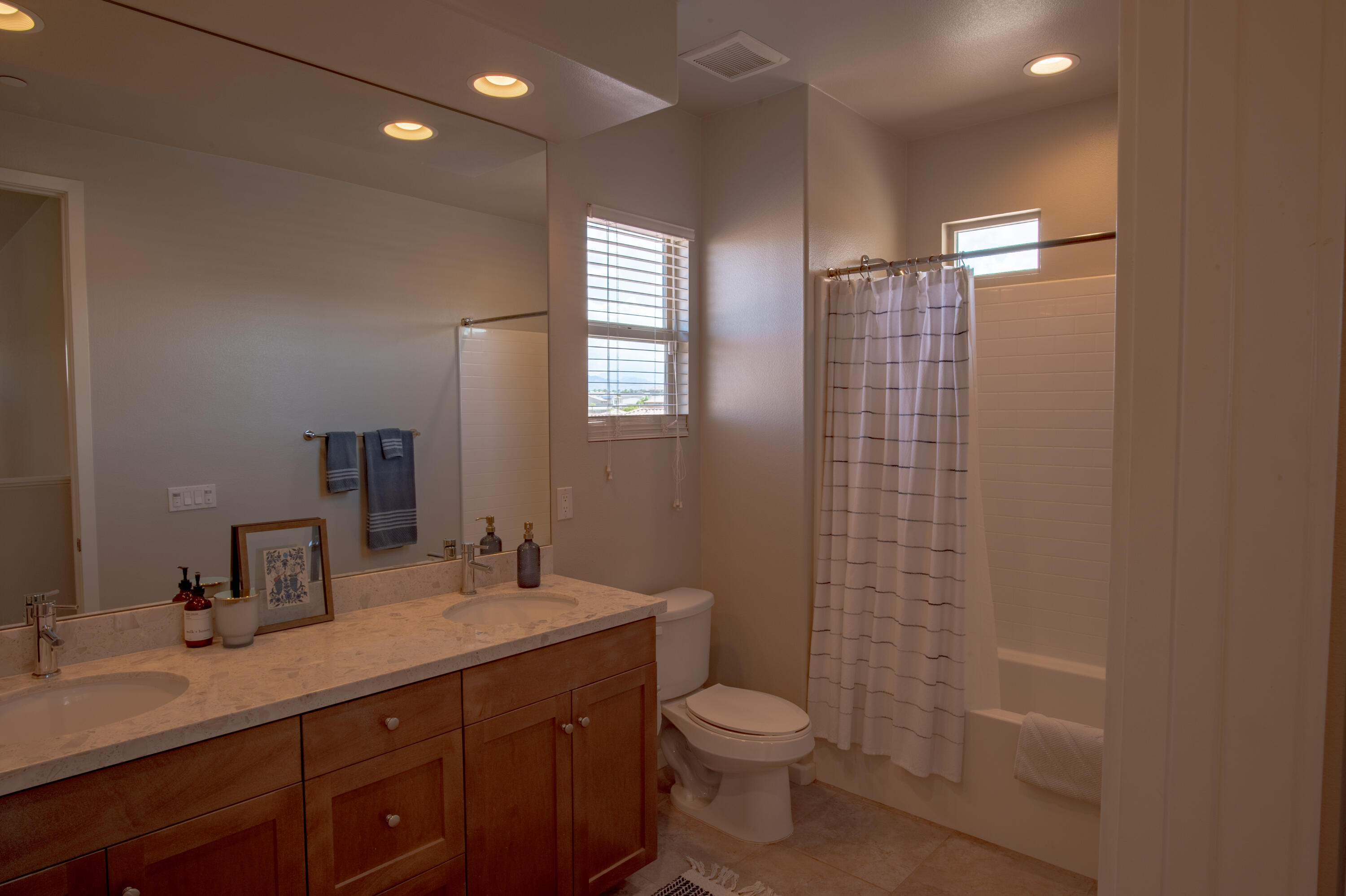 74500 Xander Court Palm Desert, CA 92211 - Photo 34 of 36 a bathroom with a double vanity sink toilet and shower