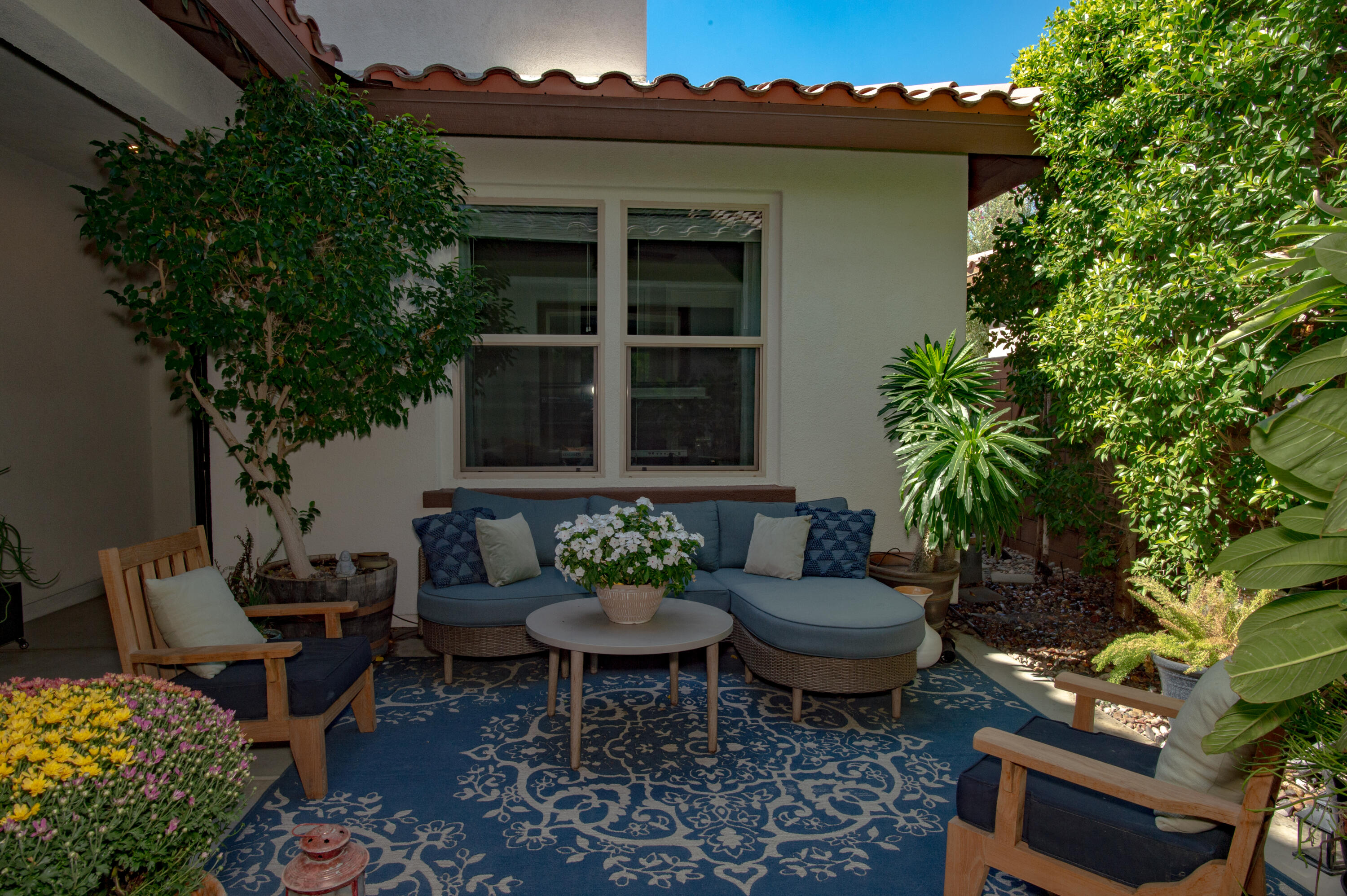 74500 Xander Court Palm Desert, CA 92211 - Photo 6 of 36 a view of a patio with couches table and chairs and potted plants