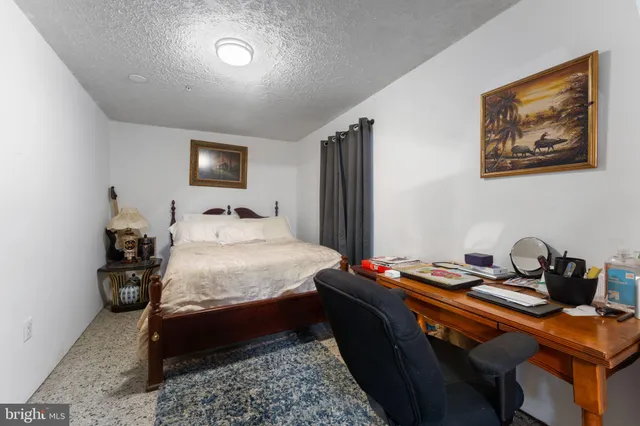 a bedroom with a bed and a table in it