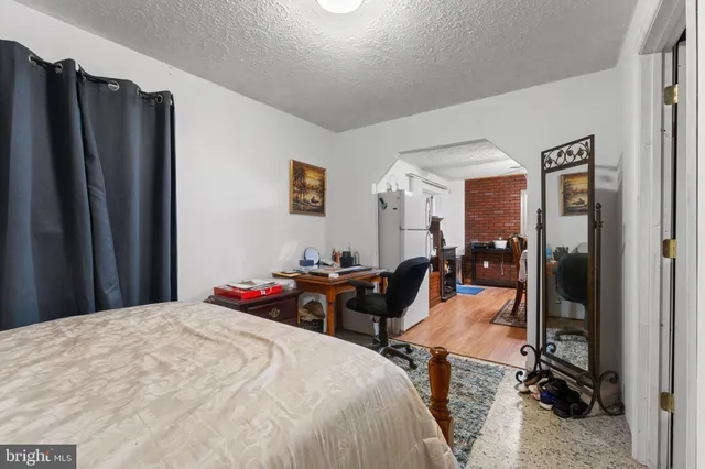 a bed room with a bed and a large mirror