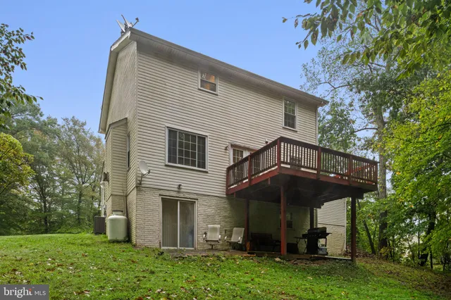 a view of a patio with table and chairs under an umbrella