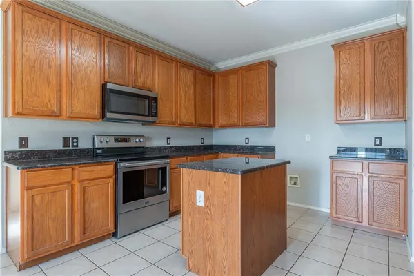 a kitchen with stainless steel appliances granite countertop wooden cabinets a stove top oven a sink and dishwasher