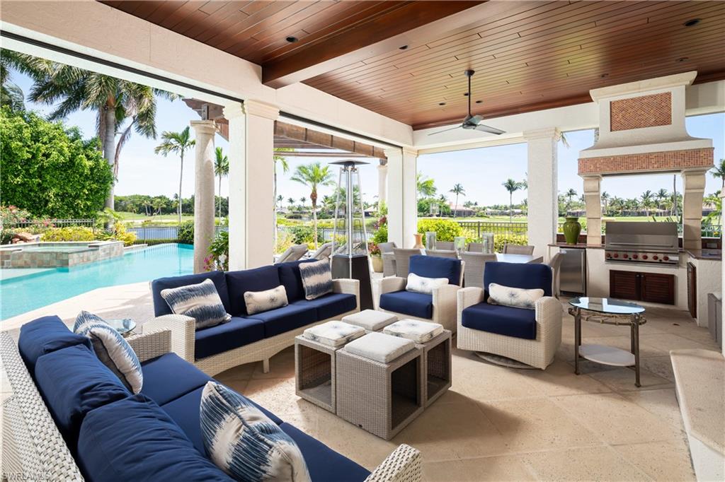 2145 Canna Way Naples, FL 34105 - Photo 16 of 49 a living room with furniture and a large window
