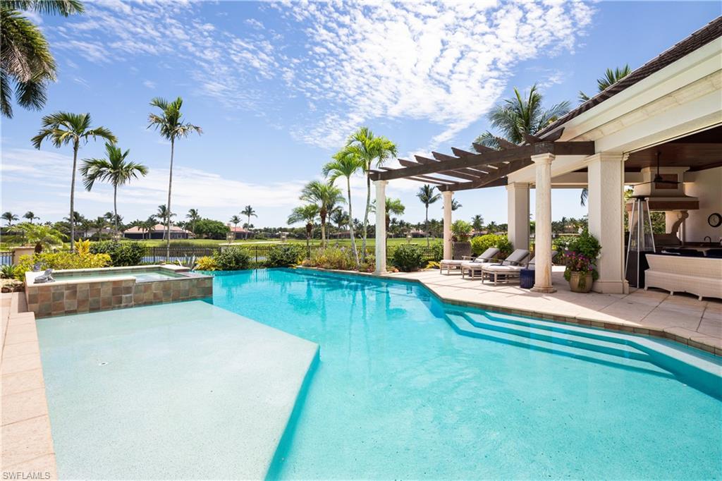 2145 Canna Way Naples, FL 34105 - Photo 19 of 49 a view of a patio with swimming pool