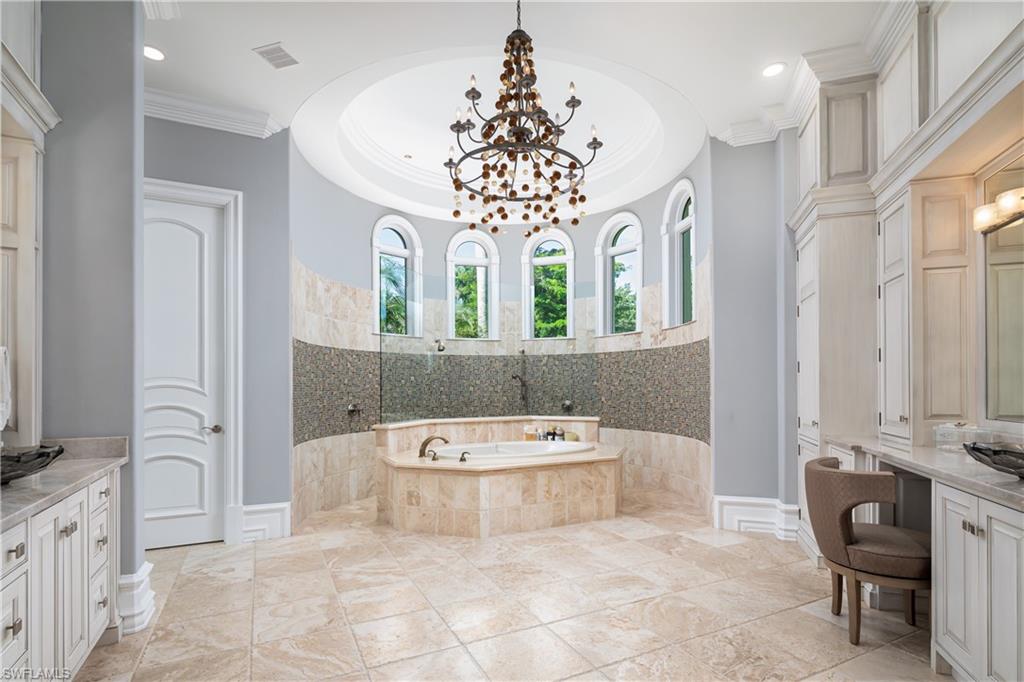 2145 Canna Way Naples, FL 34105 - Photo 31 of 49 a bathroom with a tub sink and mirror