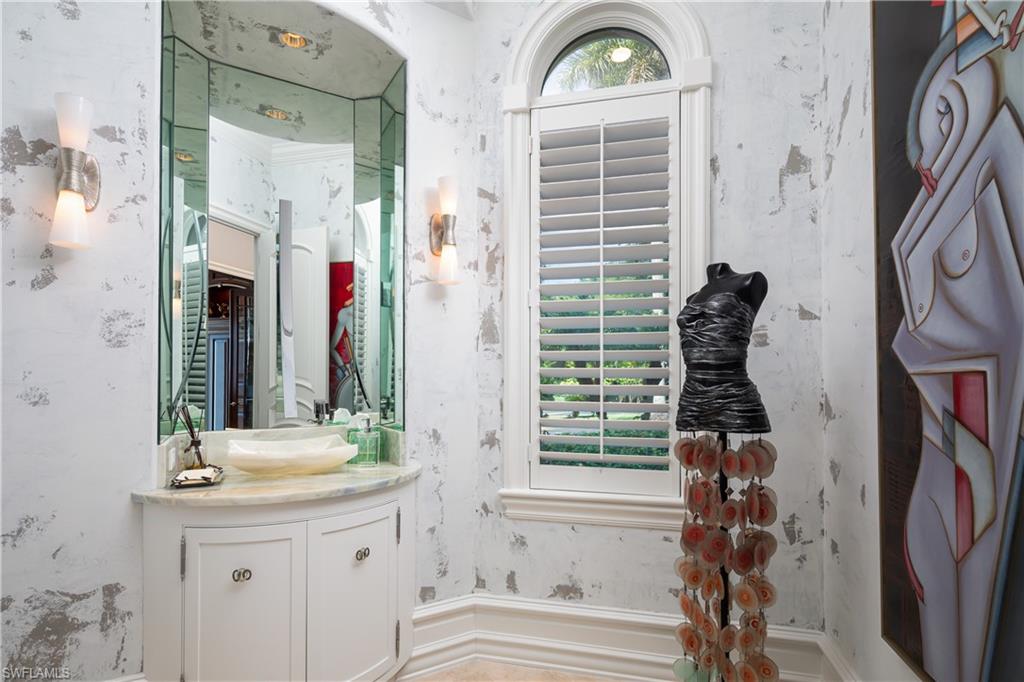 2145 Canna Way Naples, FL 34105 - Photo 32 of 49 a bathroom with a sink a mirror and a window