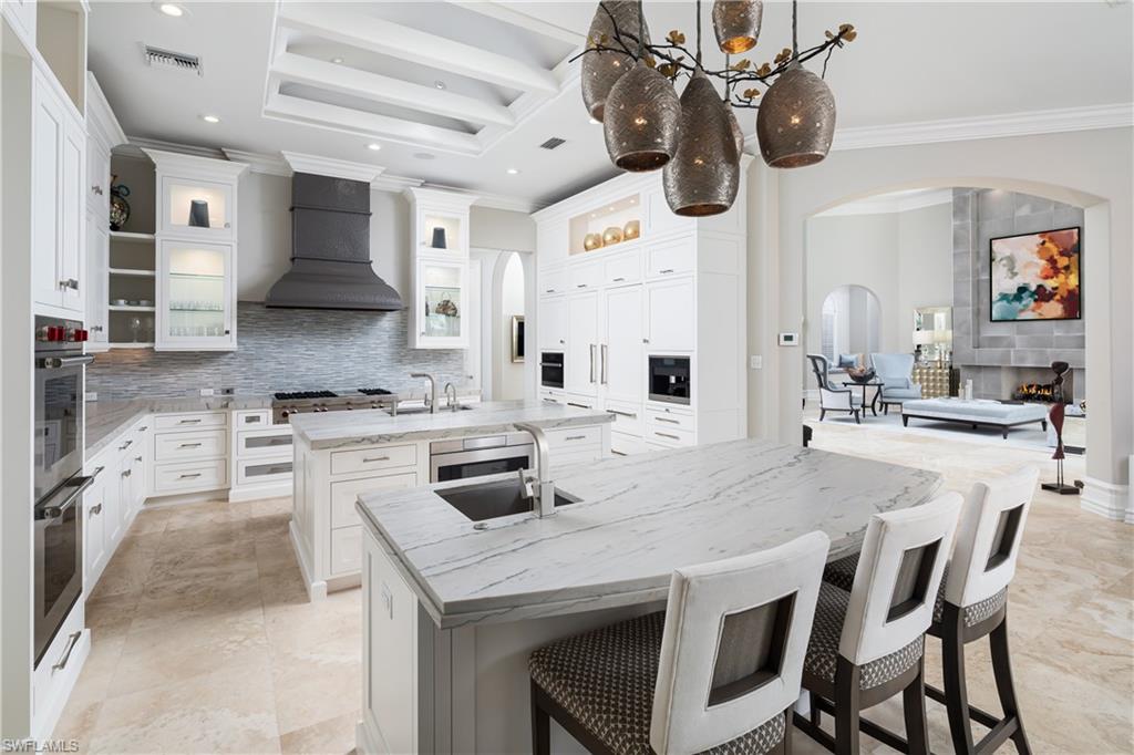 2145 Canna Way Naples, FL 34105 - Photo 10 of 49 a kitchen with stainless steel appliances kitchen island granite countertop a sink and cabinets