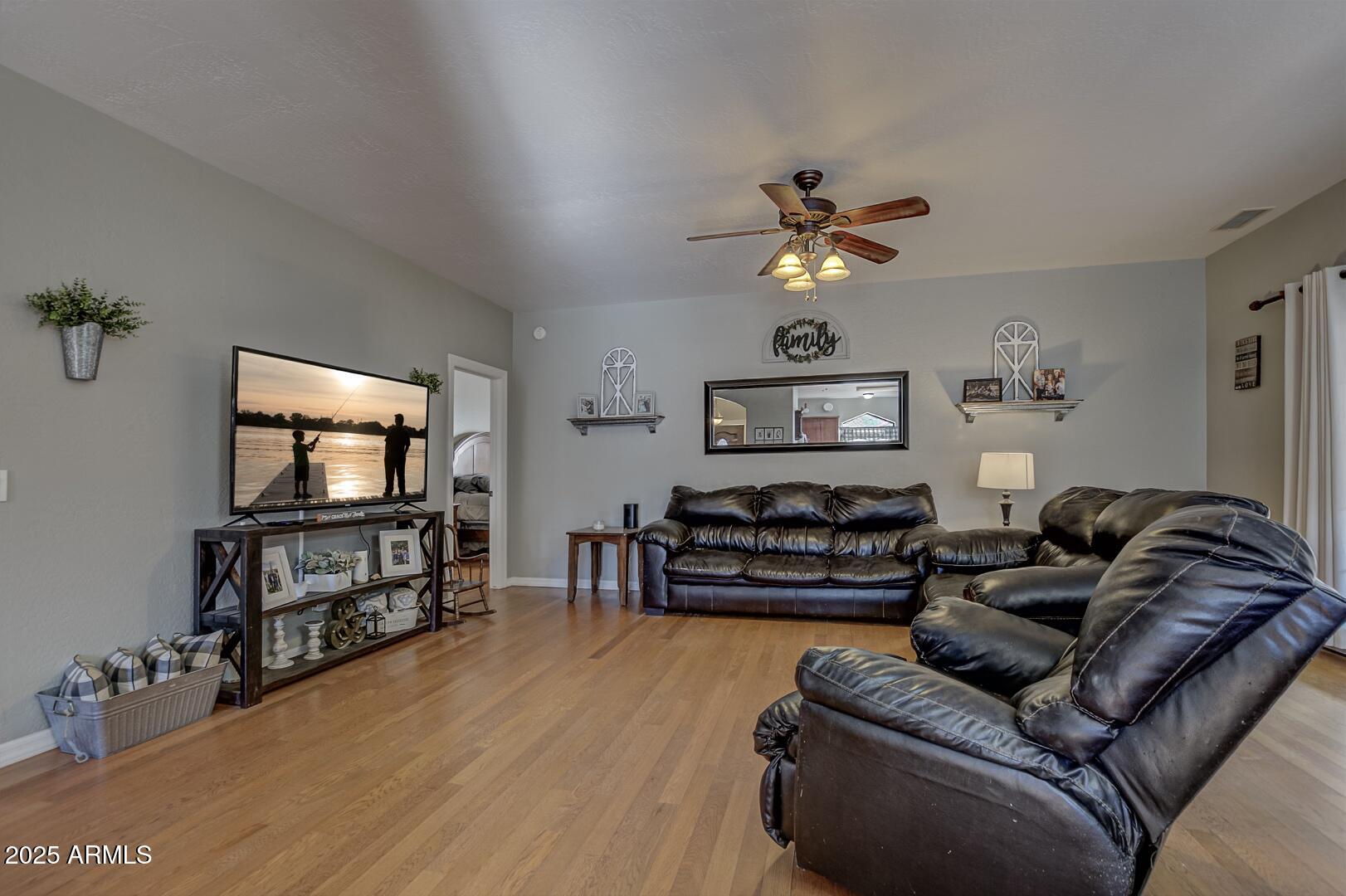 406 Granite Butte Road Star Valley, AZ 85541 - Photo 15 of 24 a living room with furniture and a flat screen tv with kitchen view