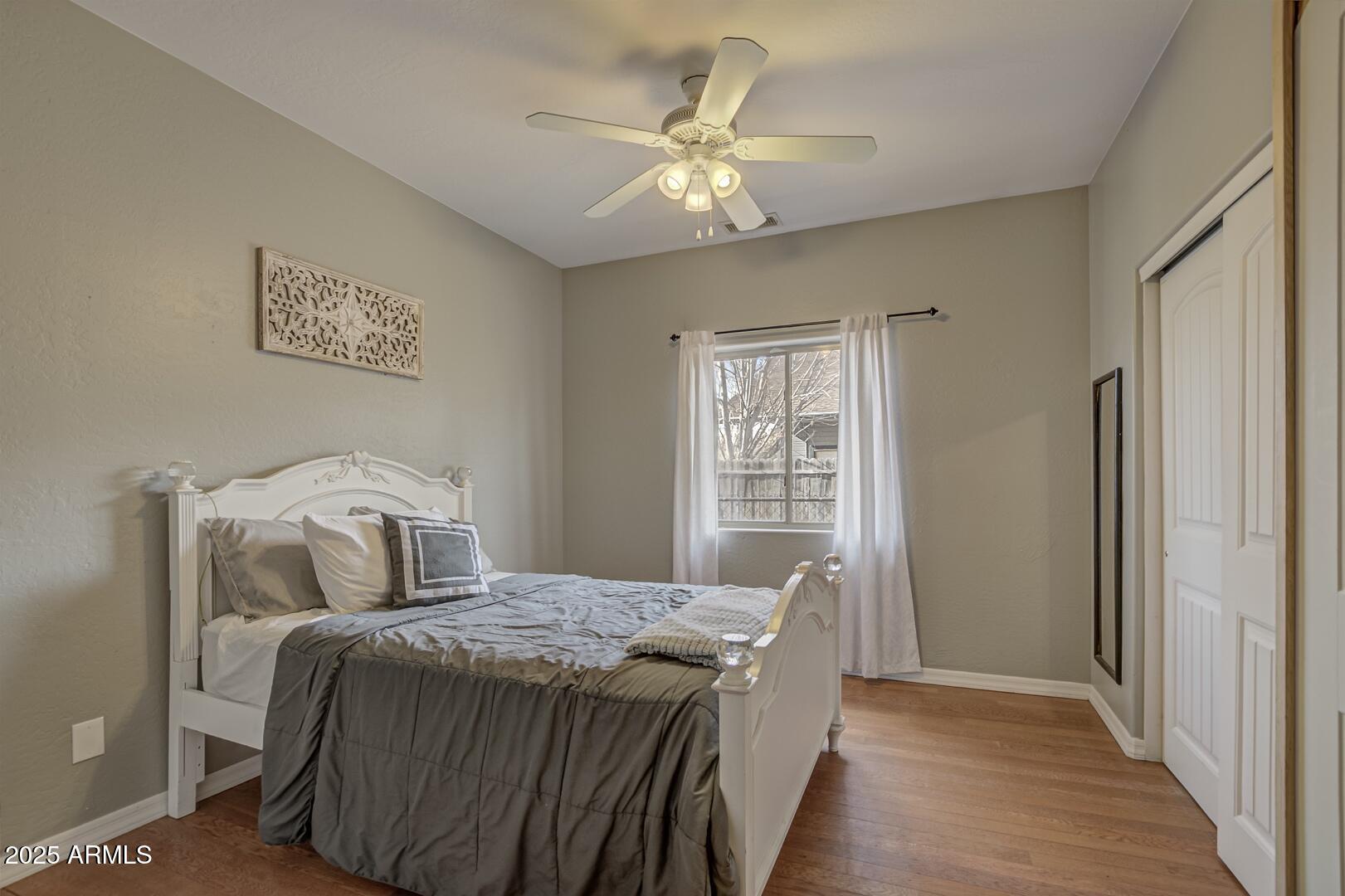 406 Granite Butte Road Star Valley, AZ 85541 - Photo 17 of 24 a bedroom with a large bed and a chandelier