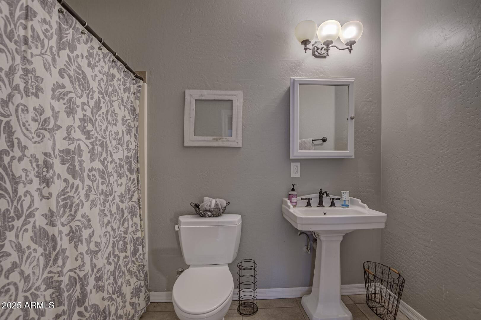 406 Granite Butte Road Star Valley, AZ 85541 - Photo 19 of 24 a bathroom with a sink toilet and a mirror