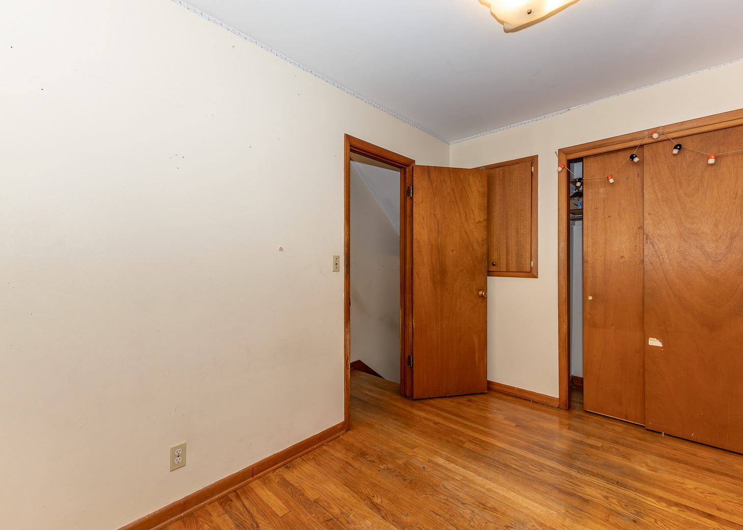 1608 3rd Street Camanche, IA 52730 - Photo 13 of 25 a view of an empty room with wooden floor