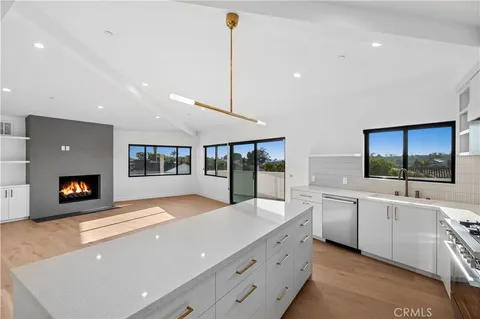 a large white kitchen with a large window