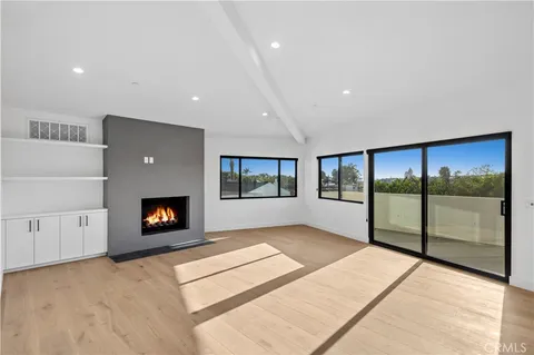 a living room with fireplace furniture and a flat screen tv