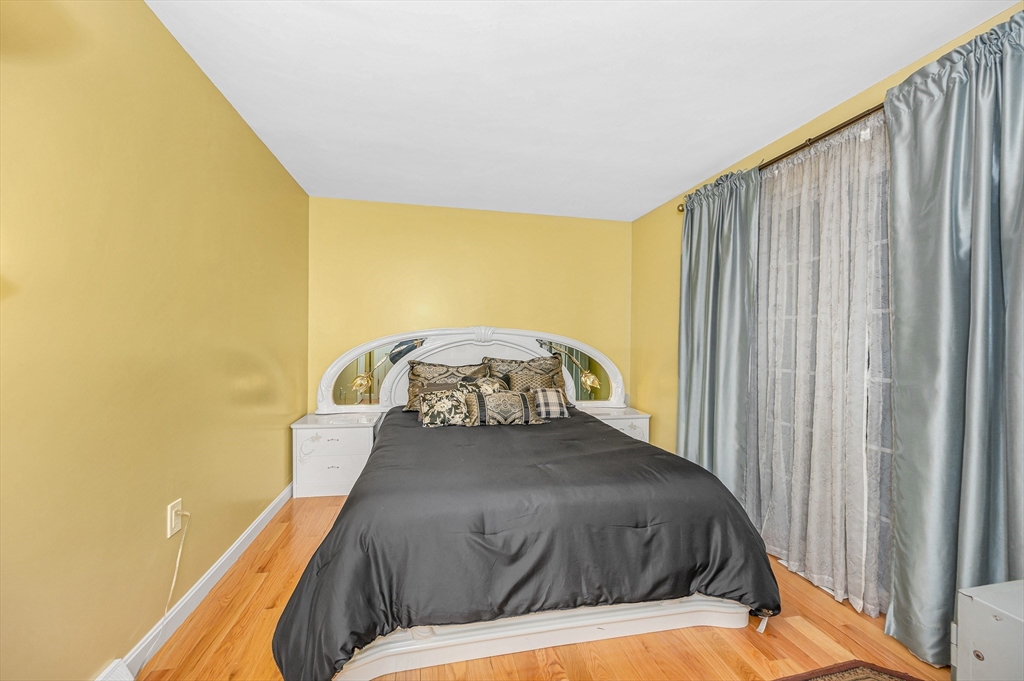 454 Dunstable Road Tyngsborough, MA 01879 - Photo 15 of 41 a bed sitting in a bedroom next to a window