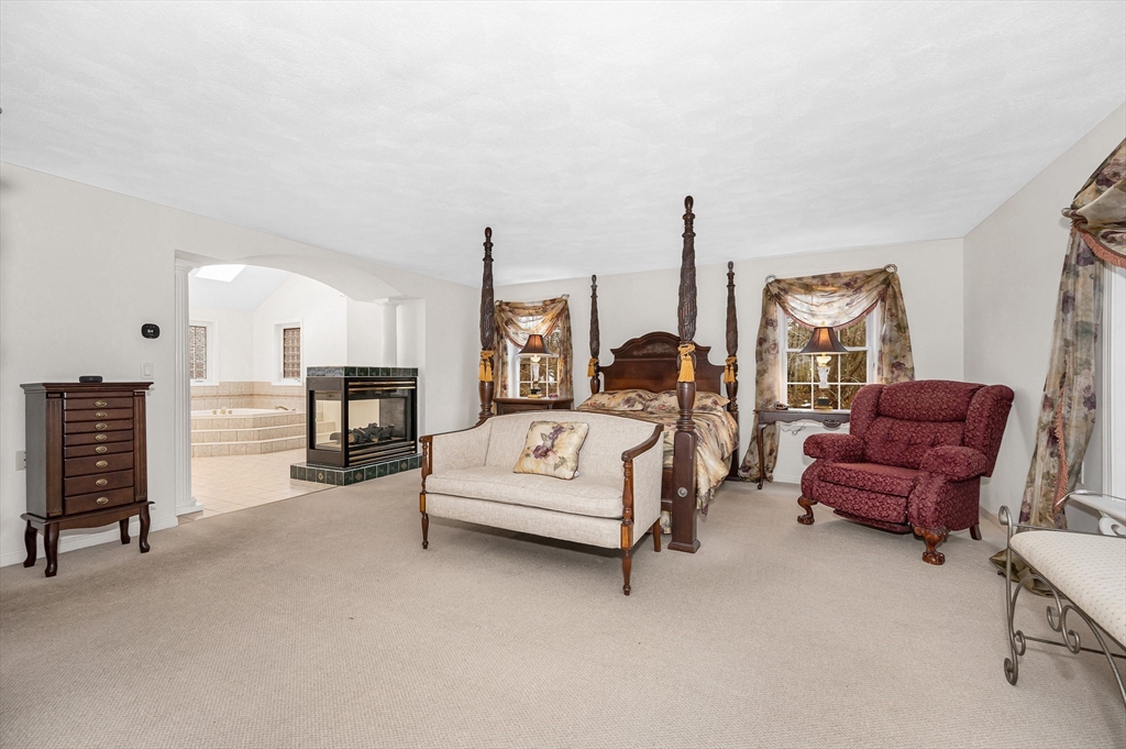 454 Dunstable Road Tyngsborough, MA 01879 - Photo 19 of 41 a living room with furniture and a chandelier