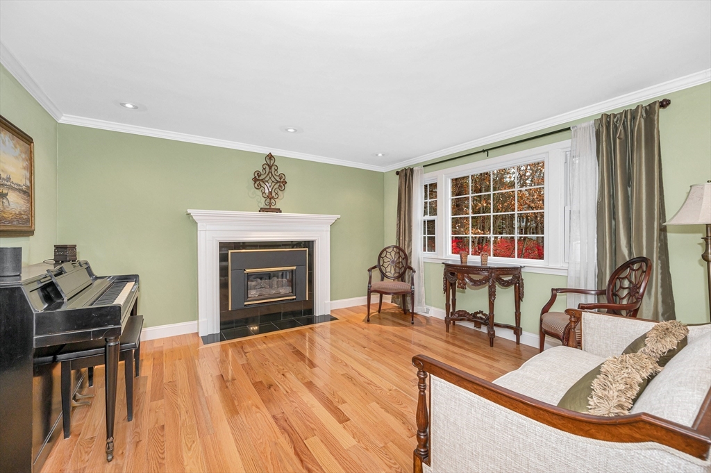 454 Dunstable Road Tyngsborough, MA 01879 - Photo 2 of 41 a living room with furniture and a fireplace