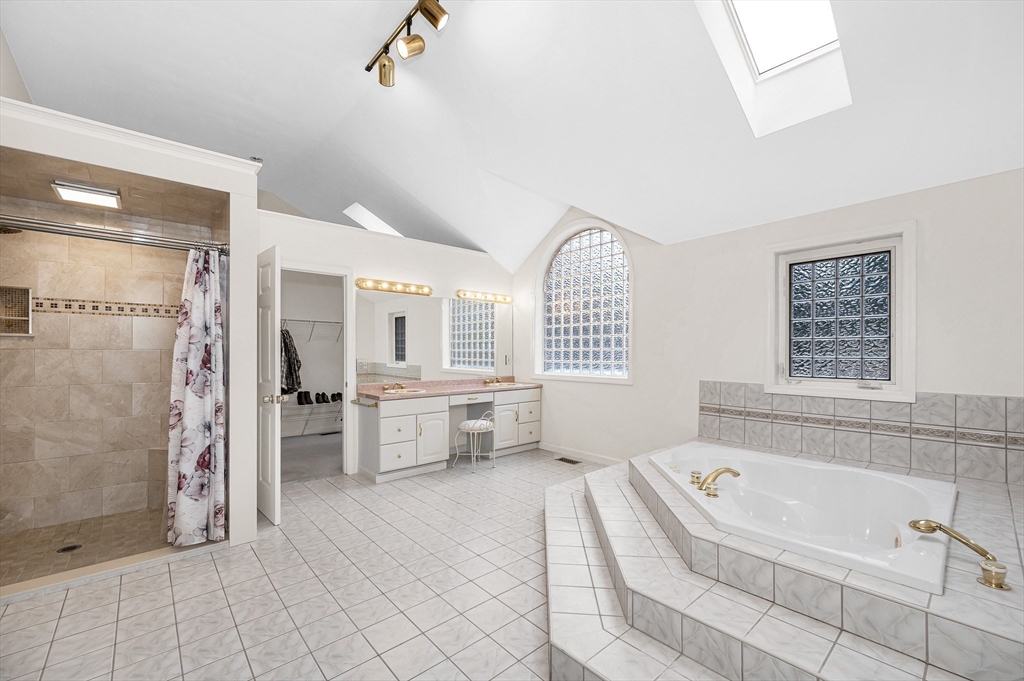 454 Dunstable Road Tyngsborough, MA 01879 - Photo 21 of 41 a bathroom with a bathtub and a shower